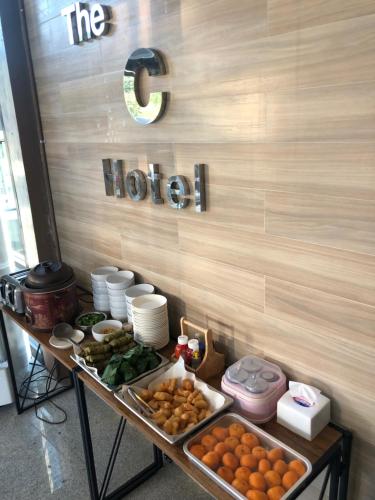 a buffet of food on a table in a restaurant at The C Hotel in Amnat Charoen