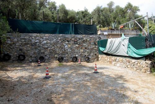 a stone wall with orange and white traffic cones at Villa Caribe affittacamere in Monterosso al Mare