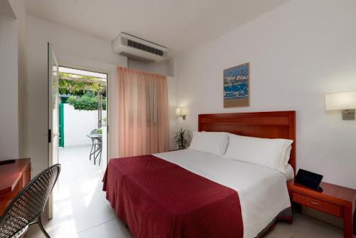Säng eller sängar i ett rum på Hotel Club Village Maritalia