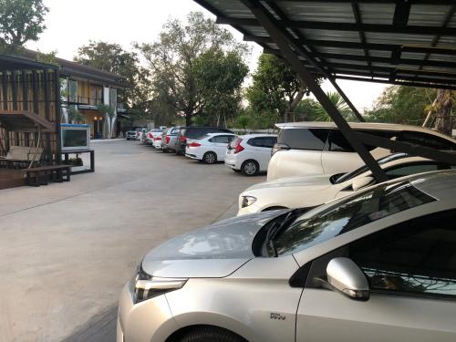 a row of parked cars in a parking lot at The C Hotel in Amnat Charoen