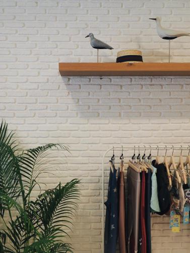 a shelf with clothes and a bird on it at Summer Stay Sattahip in Sattahip