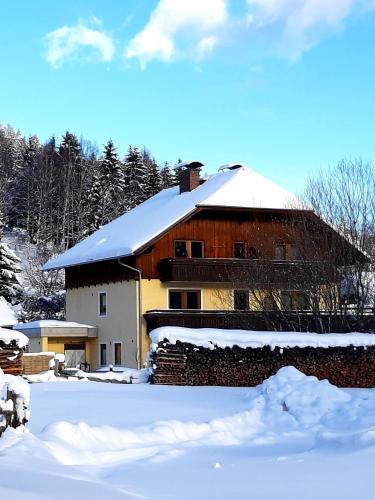 a barn with snow on top of it at Haus Untermühle in Mariapfarr