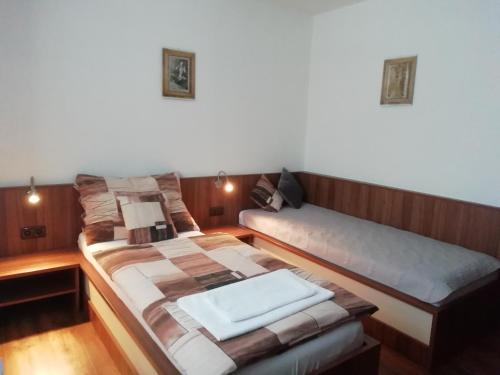 a room with two beds in a room at Motorest U Kola in Prostějov