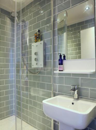 a bathroom with a sink and a mirror at The Dark Horse Pub in Bristol