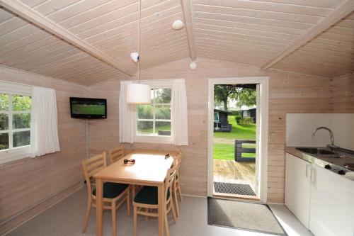 a kitchen and dining room with a table and chairs at Camp Hverringe in Dalby