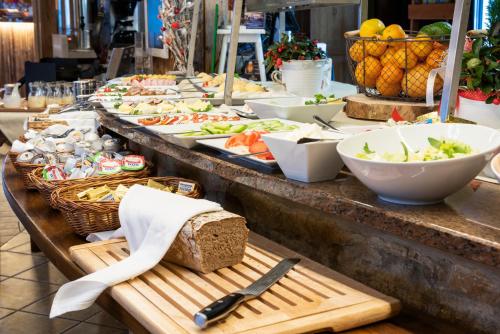 a buffet of food on a table in a store at Vital&Spa Resort Szarotka in Duszniki Zdrój