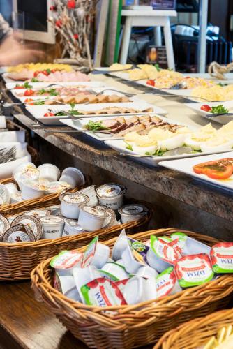 a buffet with many different types of food in baskets at Vital&Spa Resort Szarotka in Duszniki Zdrój