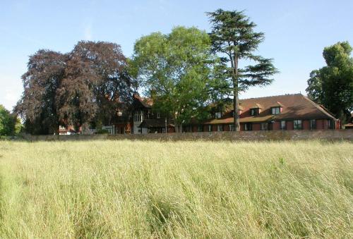 a house in the middle of a field of tall grass at CIM Business Centre in Maidenhead