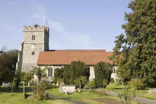 an old stone church with a tower in a cemetery at CIM Business Centre in Maidenhead