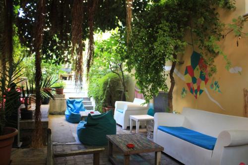 a patio with couches and a table and trees at The Beehive in Rome