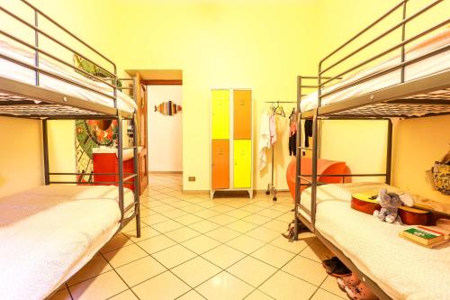 a room with two bunk beds and a room with a hallway at The Beehive in Rome