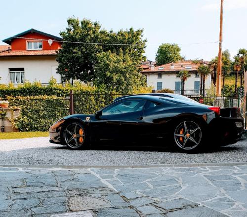 a black car parked on the side of a street at La Turr de Mezz- Bellagio LCA in Bellagio
