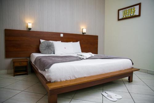 A bed or beds in a room at Paloma Hotel Ring Road