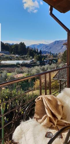 a balcony with a view of a field and mountains at La Turr de Mezz- Bellagio LCA in Bellagio