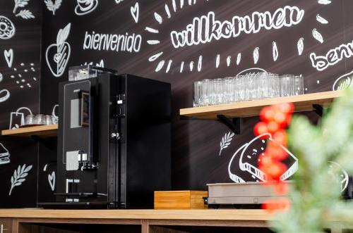 a restaurant with a black wall with white writing on it at Appart-Pension Schnöll in Mittersill