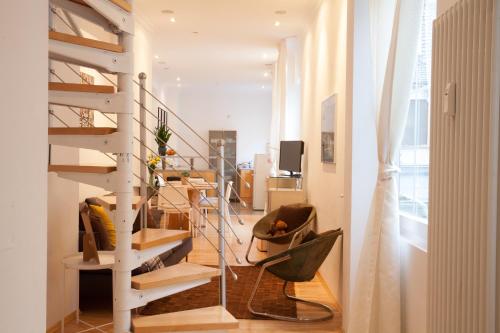 a living room with a spiral staircase in a house at Heidelberg Apheartments in Heidelberg