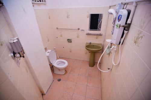 a small bathroom with a toilet and a sink at Vintage Homestay in Perai