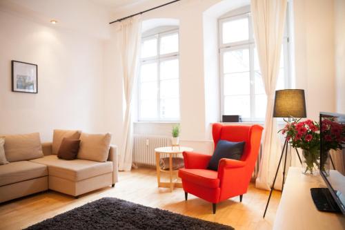 a living room with a couch and a chair at Heidelberg Apheartments in Heidelberg