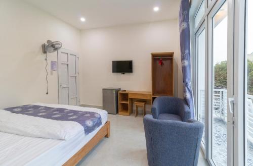 a bedroom with a bed and a chair and a desk at MrLee Dalat House in Da Lat