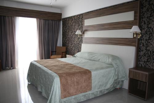A bed or beds in a room at El Aguila del Tuyú