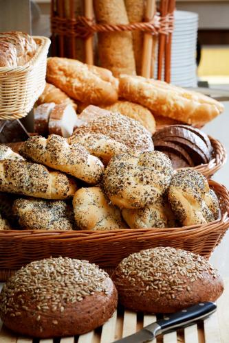 a basket of different types of bread and pastries at Spa Resort Libverda - Hotel Lesní Zátiší in Lázně Libverda