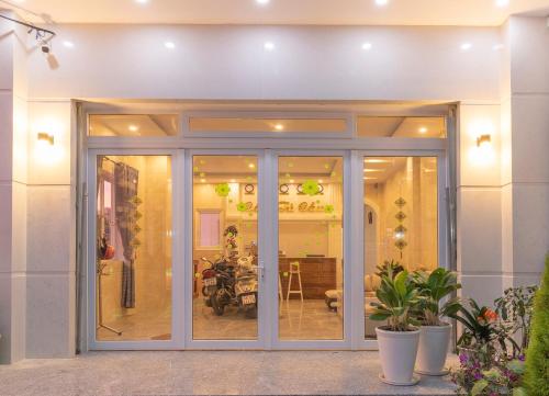 a sliding glass door in a building with plants at MrLee Dalat House in Da Lat