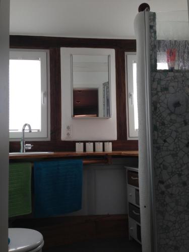 a bathroom with a sink and a microwave at CasaNova in Bad Windsheim