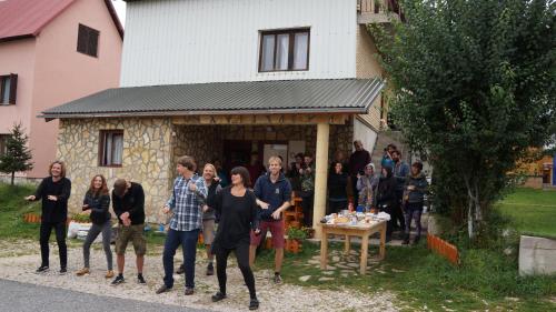 a group of people standing outside of a house at Apartments & Rooms Vitko in Žabljak