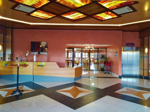 a lobby with a reception desk in a building at Hotel Cigoland in Kintzheim