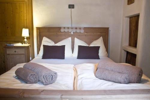 a bed with two pillows on top of it at Contrada Beltramelli in Villa di Tirano
