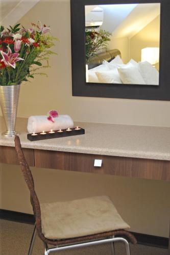 a counter with a chair and a mirror at The Lofts in Polokwane