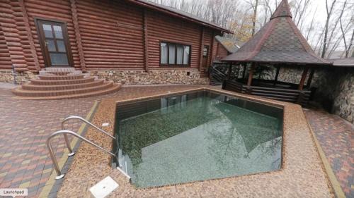 a swimming pool in the backyard of a house at Country club in Uzhhorod