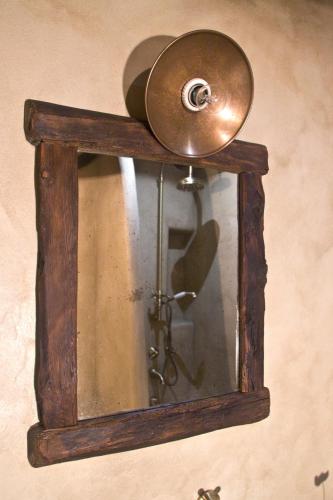 a clock on a wall with a wooden frame at Contrada Beltramelli in Villa di Tirano