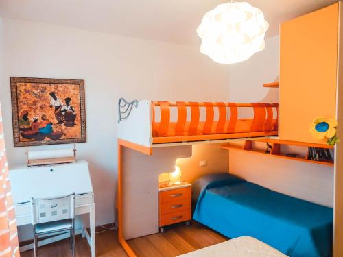 a bedroom with two bunk beds and a desk at Guest House Le Acacie in Spoltore