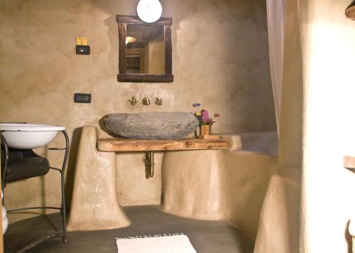 a bathroom with a sink and a tub at Contrada Beltramelli in Villa di Tirano