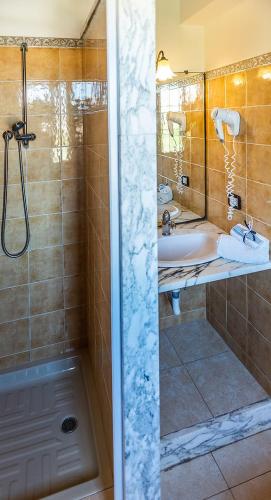 a bathroom with a shower and a sink and a tub at SCIUSCIA' in Alcamo Marina