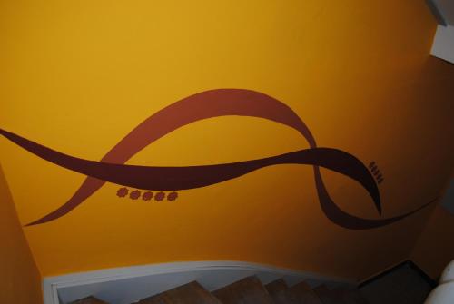 a wall with a painting of a snake on it at CasaNova in Bad Windsheim