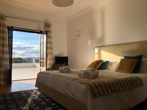 a bedroom with a large bed with towels on it at Casa da Retorta in Alcains