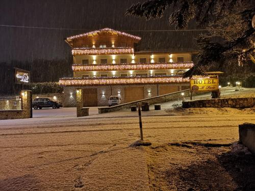 a large building with lights on it in the snow at Boutique Hotel Il Riccio - Adults Only in Roccaraso