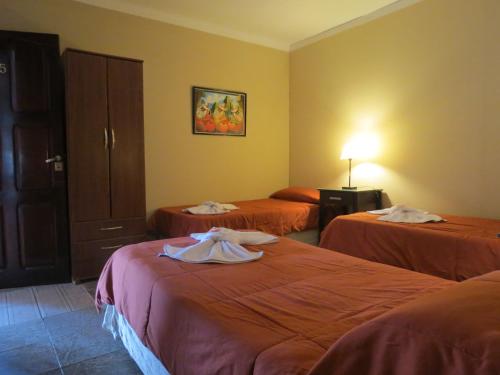 Habitación de hotel con 2 camas y toallas. en Hotel Pachá en Salta