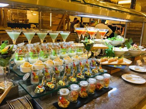 a buffet of food with drinks and appetizers at Al Bahar Hotel & Resort in Fujairah