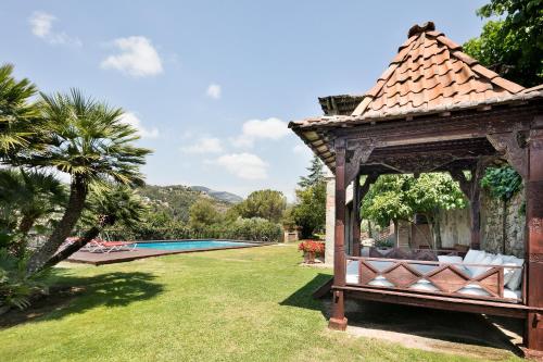 a gazebo in a yard with a pool at Can Borrell Villa Carmen in Castellar