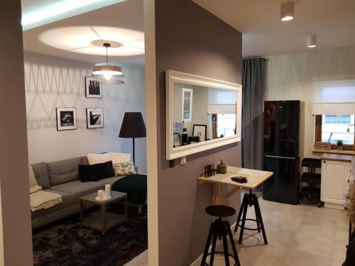 a living room with a couch and a table at Apartament MALTA COMFORT Wes Quality Suite in Poznań