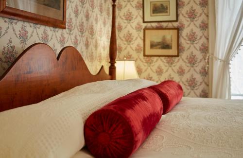 a red blanket laying on top of a bed at The Red Lion Inn in Stockbridge