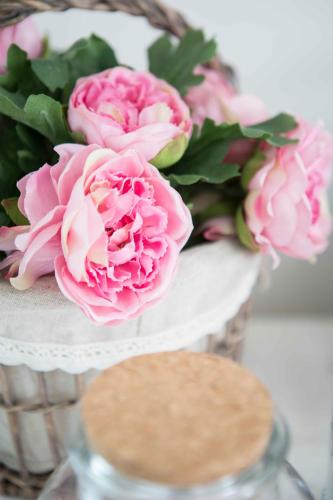 a vase of pink flowers on a white table at La Casa Di Menny Maison de Campagne in Moneglia