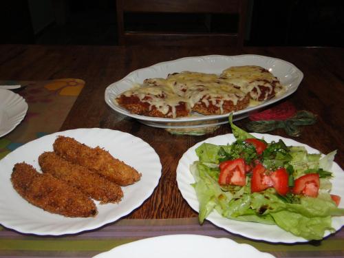 a table with three plates of food and a salad at Hotel Pousada Arco Iris in Barra de Santo Antônio
