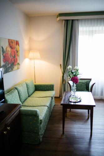 a living room with a couch and a table at Friesachers Aniferhof in Anif