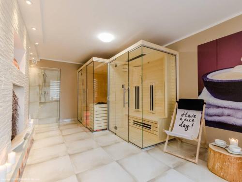 a bathroom with a walk in shower and a glass shower stall at Przystań Jagoda - pokoje i domki in Ostrowo