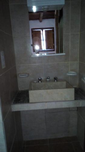 a bathroom with a sink and a mirror at El Alto de las Paredes in San Rafael