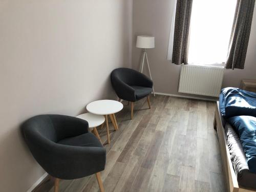 a living room with two chairs and a couch at Apartmán Marcello in Trenčianske Teplice